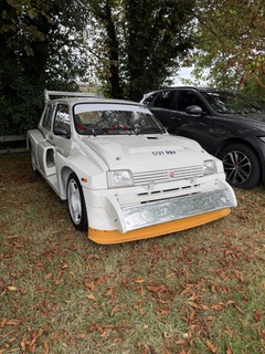 A white racing car parked up outside the museum